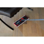 Vileda Ultramax TURBO flat mop reaching easily under low furniture due to its 180-degree swivel joint.
