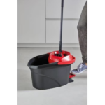 Placing the Vileda Ultramax flat mop into the spin wringer of the TURBO bucket.
