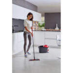 Woman using the Vileda Ultramax TURBO flat mop to clean a modern kitchen floor.